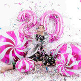 Girl celebrating Birthday with pink number Balloons in 40 INch and confetti