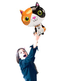 Girl holding calico cat foil balloon