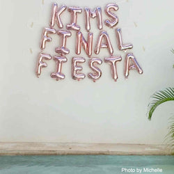 Final Fiesta letter balloons in rose gold shown on wall backdrop