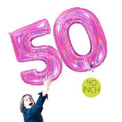 Girl holding big Glitter fuchsia number 50 balloons