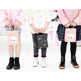 children holding halloween treat bags in pink boo and black bats