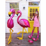 girl holding pink flamingo airwalker balloons