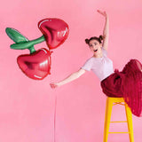 girl holding red cherry foil balloon