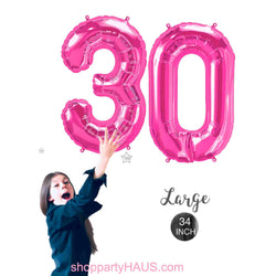 Girl holding 34 inch tall Pink number 30 balloons by northstar balloons, perfect for 30th birthday decorations