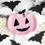 Pink Pumpkin paper plates lifestyle photo with bl;ack bat napkins and gold metallic cobweb paper table decorations