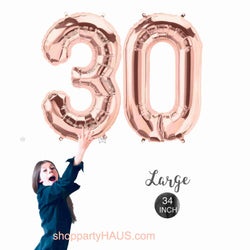 Girl holding 34 inch tall rose gold number 30 balloons by northstar balloons, perfect for 30th birthday decorations