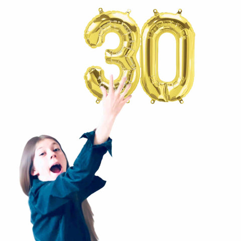 Girl holding small Gold Number 30 Balloons 13.5 IN Tall 