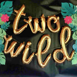 Two Wild Cursive Letter Balloons Shown in Gold